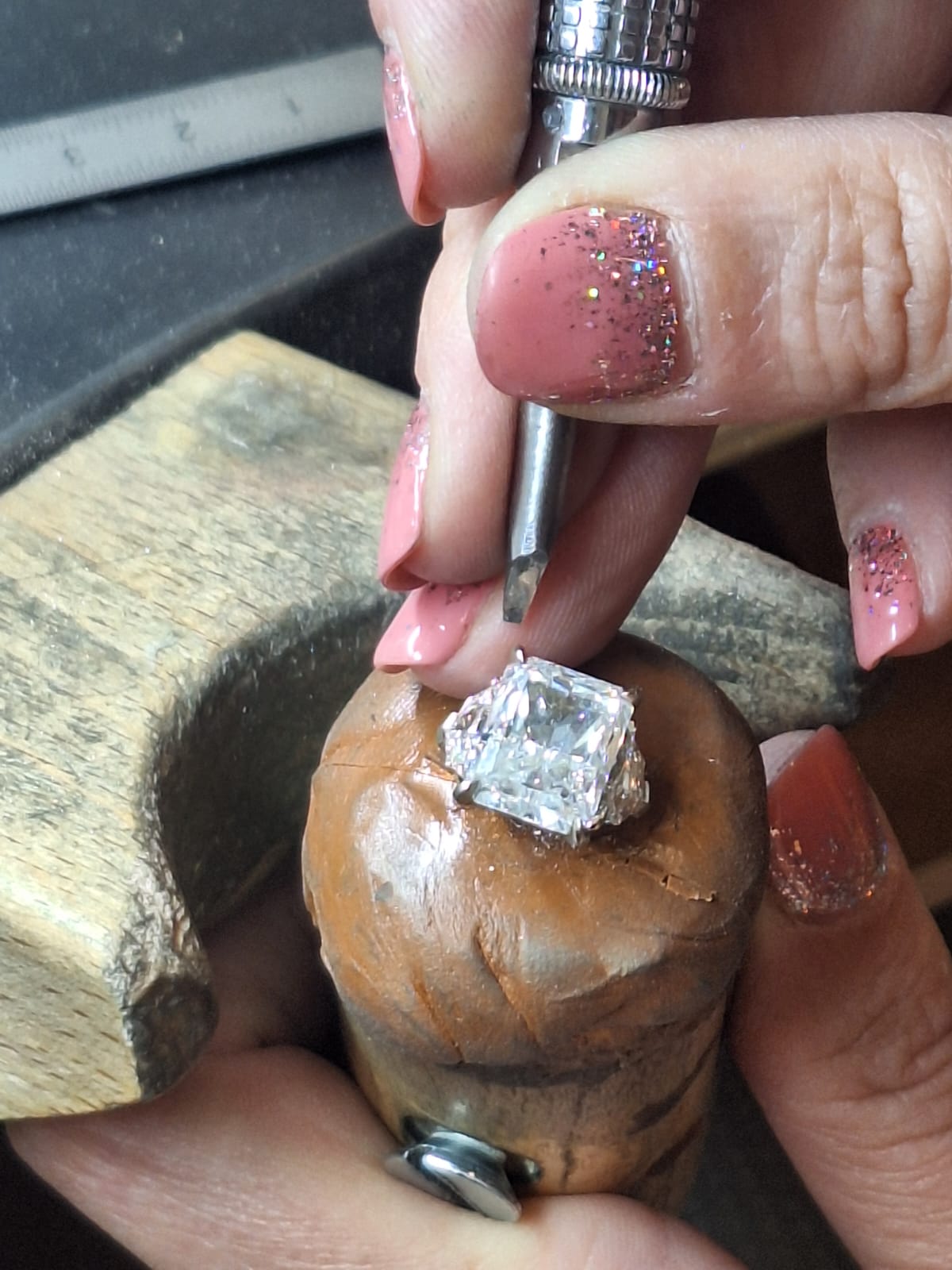 A skilled jeweller hand-finishing a bespoke diamond ring